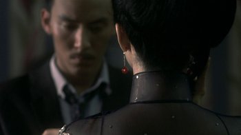 Movie still from “The Hand” (2004), directed by Kar-Wai Wong – A man and a woman looking at each other in a mirror; Close Up shot, Over the shoulder angle
