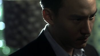 Movie still from “The Hand” (2004), directed by Kar-Wai Wong – A person wearing a suit; Close Up shot, Low angle