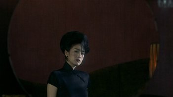 Movie still from “The Hand” (2004), directed by Kar-Wai Wong – A woman in a black dress with a black hat; Medium shot, Low angle