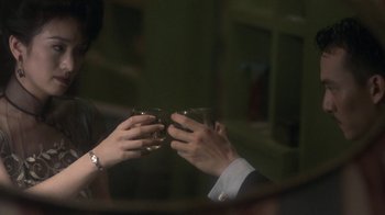 Movie still from “The Hand” (2004), directed by Kar-Wai Wong – A man and a woman are holding their hands up to each other; Close Up shot, Over the shoulder angle