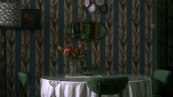 Movie still from “The Hand” (2004), directed by Kar-Wai Wong – A dining table with a vase of flowers on top of it; Wide shot, High angle