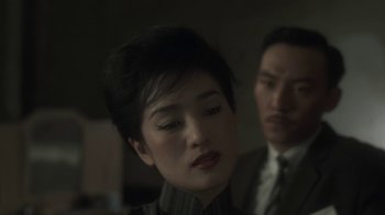 Movie still from “The Hand” (2004), directed by Kar-Wai Wong – A man and a woman are looking at the camera; Close Up shot, Over the shoulder angle