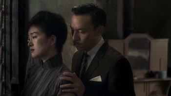 Movie still from “The Hand” (2004), directed by Kar-Wai Wong – A man and a woman in a suit and tie; Medium shot, Over the shoulder angle