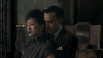 Movie still from “The Hand” (2004), directed by Kar-Wai Wong – A man and a woman are standing next to each other; Close Up shot, High angle