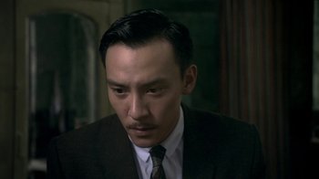 Movie still from “The Hand” (2004), directed by Kar-Wai Wong – A person wearing a suit and tie; Close Up shot, Low angle