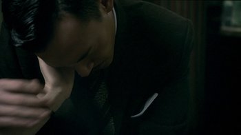 Movie still from “The Hand” (2004), directed by Kar-Wai Wong – A person wearing a suit and tie; Close Up shot, High angle