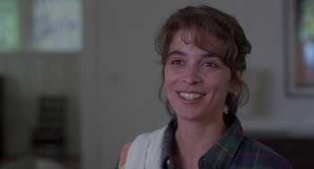 Movie still from “The Hand That Rocks the Cradle” (1992), directed by Curtis Hanson – A person smiling for the camera; Close Up shot, Over the shoulder angle