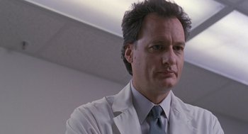 Movie still from “The Hand That Rocks the Cradle” (1992), directed by Curtis Hanson – A person wearing a lab coat; Close Up shot, Low angle