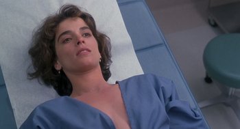 Movie still from “The Hand That Rocks the Cradle” (1992), directed by Curtis Hanson – A person laying on a bed; Close Up shot, High angle