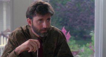 Movie still from “The Hand That Rocks the Cradle” (1992), directed by Curtis Hanson – A man with a beard is wearing a tie; Close Up shot, Over the shoulder angle