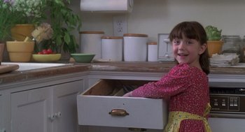Movie still from “The Hand That Rocks the Cradle” (1992), directed by Curtis Hanson – A little girl standing in a kitchen drawer; Medium shot, Low angle