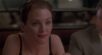 Movie still from “The Hand That Rocks the Cradle” (1992), directed by Curtis Hanson – A person sitting on a chair; Close Up shot, Over the shoulder angle
