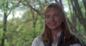 Movie still from “The Hand That Rocks the Cradle” (1992), directed by Curtis Hanson – A person wearing a vest and smiling; Close Up shot, Over the shoulder angle