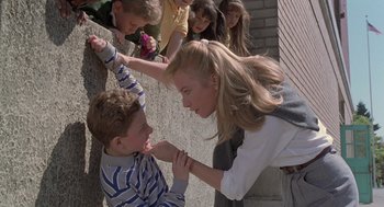 Movie still from “The Hand That Rocks the Cradle” (1992), directed by Curtis Hanson – A young boy and a girl are touching each other's face; Medium shot, Over the shoulder angle