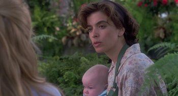 Movie still from “The Hand That Rocks the Cradle” (1992), directed by Curtis Hanson – A woman holding a baby in her arms; Close Up shot, Over the shoulder angle