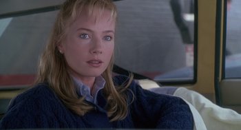 Movie still from “The Hand That Rocks the Cradle” (1992), directed by Curtis Hanson – A woman sitting in the back seat of a car; Close Up shot, Over the shoulder angle