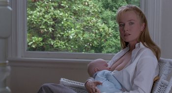 Movie still from “The Hand That Rocks the Cradle” (1992), directed by Curtis Hanson – A woman holding a baby in her arms; Close Up shot, Low angle