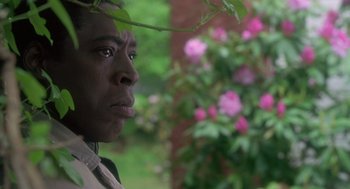 Movie still from “The Hand That Rocks the Cradle” (1992), directed by Curtis Hanson – A person looking at the camera; Close Up shot, Low angle