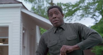 Movie still from “The Hand That Rocks the Cradle” (1992), directed by Curtis Hanson – A man in a green shirt looking at the camera; Close Up shot, Low angle