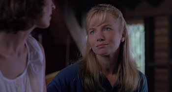 Movie still from “The Hand That Rocks the Cradle” (1992), directed by Curtis Hanson – A woman with long blonde hair and blue eyes looking up; Close Up shot, Over the shoulder angle