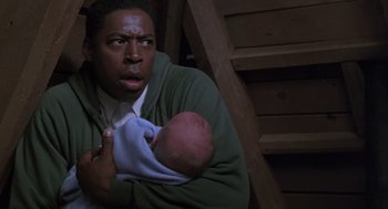 Movie still from “The Hand That Rocks the Cradle” (1992), directed by Curtis Hanson – A man holding a baby in his arms; Close Up shot, High angle