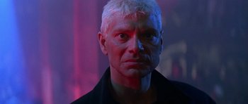 Movie still from “The Hard Way” (1991), directed by John Badham – A person wearing a black shirt; Close Up shot, Low angle