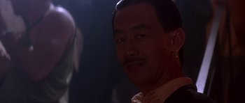 Movie still from “The Hard Way” (1991), directed by John Badham – A person wearing a suit and tie; Close Up shot, Over the shoulder angle