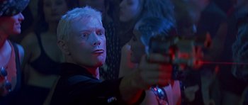 Movie still from “The Hard Way” (1991), directed by John Badham – A person taking a picture with a cell phone; Close Up shot, Low angle