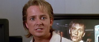 Movie still from “The Hard Way” (1991), directed by John Badham – A person with long blonde hair; Close Up shot, Low angle