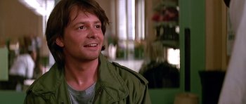 Movie still from “The Hard Way” (1991), directed by John Badham – A person wearing a green jacket; Close Up shot, Over the shoulder angle