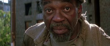 Movie still from “The Hard Way” (1991), directed by John Badham – A person with a beard; Close Up shot, Low angle