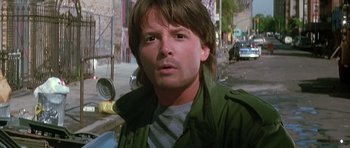 Movie still from “The Hard Way” (1991), directed by John Badham – A person wearing a green jacket; Close Up shot, Low angle