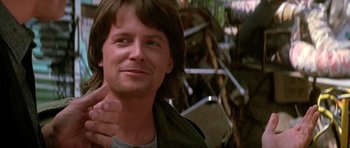 Movie still from “The Hard Way” (1991), directed by John Badham – A person with a horse in the background; Close Up shot, Low angle