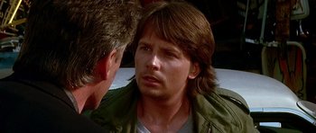 Movie still from “The Hard Way” (1991), directed by John Badham – A person talking to another person; Close Up shot, Over the shoulder angle