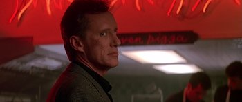 Movie still from “The Hard Way” (1991), directed by John Badham – A person in a room; Close Up shot, Low angle