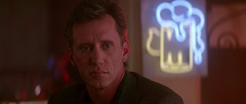 Movie still from “The Hard Way” (1991), directed by John Badham – A person wearing a suit and tie; Close Up shot, Low angle