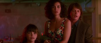Movie still from “The Hard Way” (1991), directed by John Badham – A woman standing next to a young girl in a room; Close Up shot, Low angle