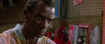 Movie still from “The Hard Way” (1991), directed by John Badham – A person in a workshop; Close Up shot, Low angle