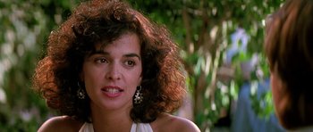 Movie still from “The Hard Way” (1991), directed by John Badham – A person with curly hair; Close Up shot, Over the shoulder angle