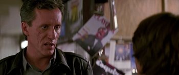 Movie still from “The Hard Way” (1991), directed by John Badham – A person wearing a black jacket; Close Up shot, Low angle