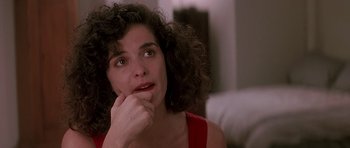Movie still from “The Hard Way” (1991), directed by John Badham – A person sitting with her hand on her chin; Close Up shot, Over the shoulder angle