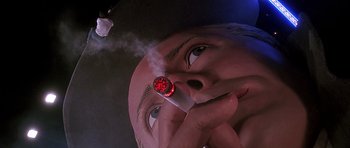 Movie still from “The Hard Way” (1991), directed by John Badham – A giant head with a cigarette in it's mouth; Extreme Close Up shot, Low angle