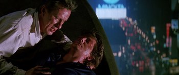 Movie still from “The Hard Way” (1991), directed by John Badham – Two men are fighting in front of a projection screen; Close Up shot, Low angle