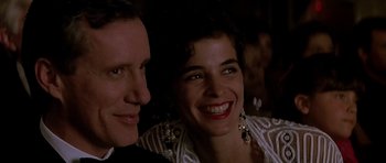 Movie still from “The Hard Way” (1991), directed by John Badham – A man and a woman smiling for the camera; Close Up shot, Low angle
