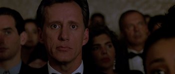 Movie still from “The Hard Way” (1991), directed by John Badham – A person wearing a suit and a bow tie; Close Up shot, Low angle