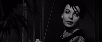 Movie still from “The Haunting” (1963), directed by Robert Wise – A black - and - white photo of a woman holding a cane; Close Up shot, Over the shoulder angle