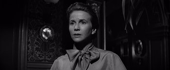 Movie still from “The Haunting” (1963), directed by Robert Wise – Black and white photograph of a woman wearing a neck tie; Close Up shot, Low angle
