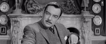 Movie still from “The Haunting” (1963), directed by Robert Wise – An old photo of a man in a suit; Close Up shot, Low angle