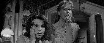 Movie still from “The Haunting” (1963), directed by Robert Wise – Two women are looking at each other while holding their hands up to their face; Close Up shot, Low angle