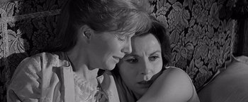 Movie still from “The Haunting” (1963), directed by Robert Wise – Two women sitting next to each other on a couch; Close Up shot, High angle